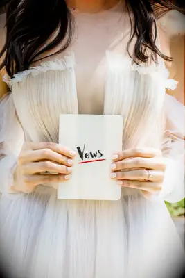 Bride Holding Handwritten Vows Notebook