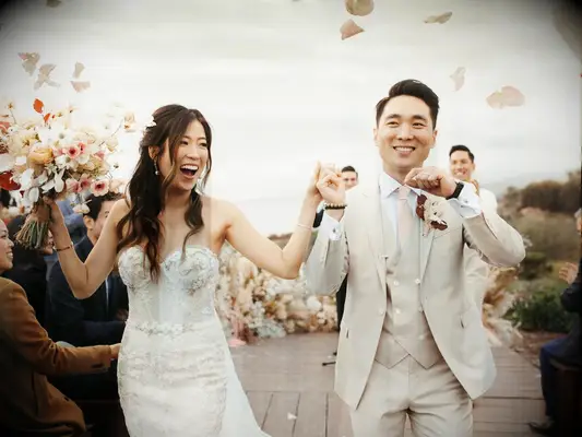 Bride and groom joyful outdoor wedding recessional