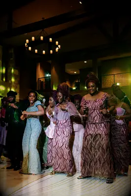 Nigerian wedding guests dancing at after party.