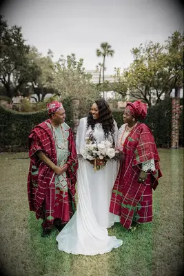 Bride with parents at Nigerian wedding ceremony