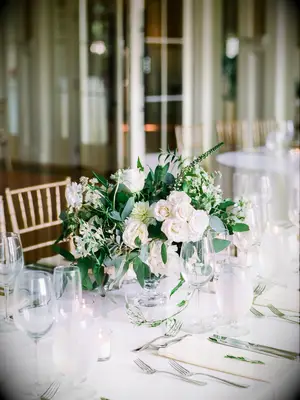 classic wedding centerpiece with white roses and eucalyptus