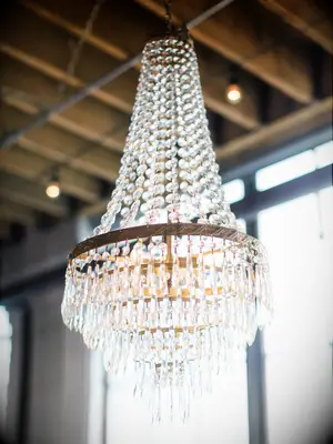 crystal chandelier hanging from ceiling at indoor wedding venue