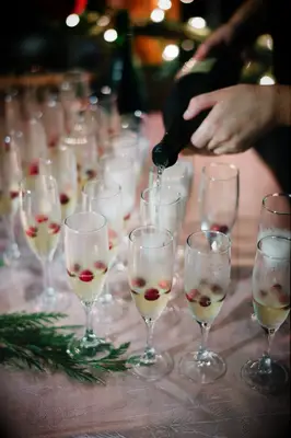 Cranberry Champagne cocktail being served at wedding. 