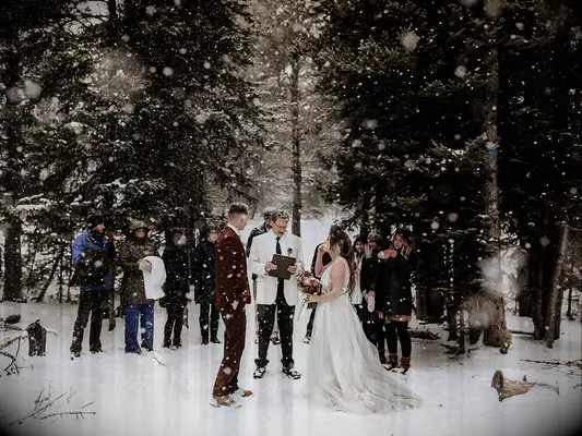 Bride and groom having on outdoor winter elopement.