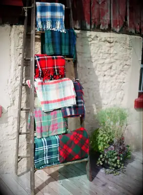 Different colors of plaid blankets at winter wedding.
