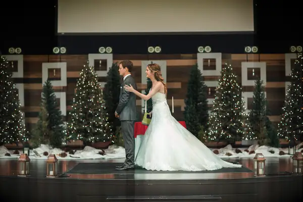 Bride and groom doing first look with Christmas tree background.