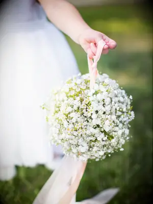 Flower girl holding flower bouquet ball