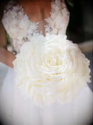 Woman carrying a large white flower bouquet