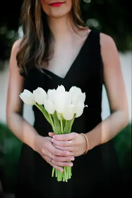 Woman carrying white tulips