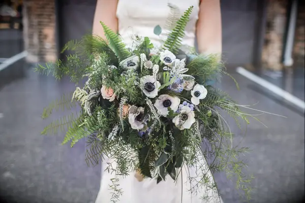 oversized wedding bouquet with sword ferns, white anemones, blue scabiosa, pink roses and greenery vines