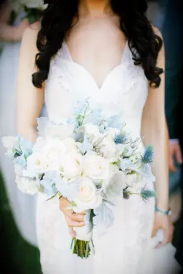 elegant light blue and white wedding bouquet with roses, thistle, delphinium and dusty miller