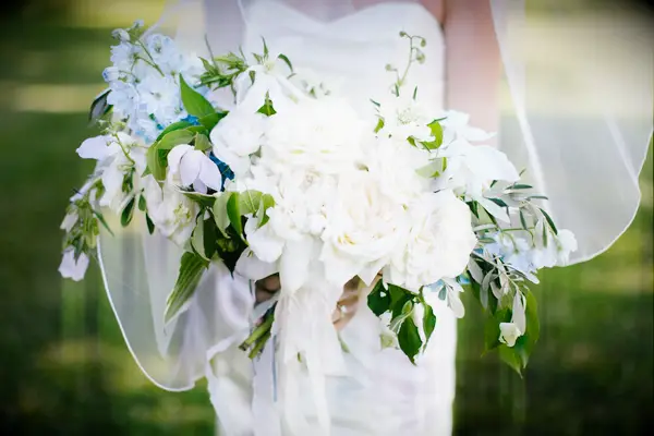 elegant hand tied wedding bouquet with white garden roses and blue delphinium