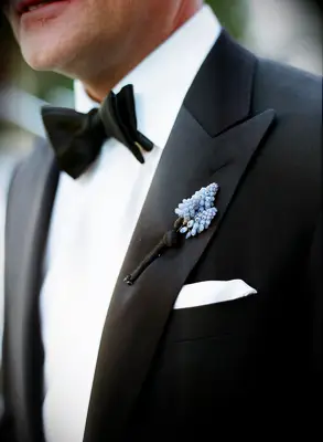 blue muscari wedding boutonniere on the lapel of groom