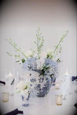 wedding centerpiece with blue and white flowers in chinoiserie vase