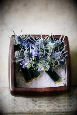 blue thistle wedding boutonnieres in shotgun shells