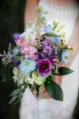 blue wedding bouquet with pink and purple flowers