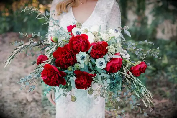 Vibrant red peony bridal bouquet with eucalyptus
