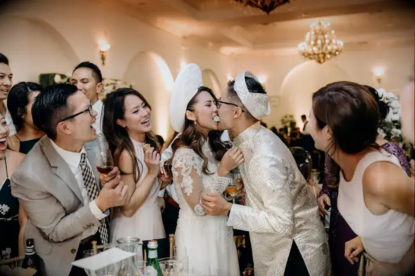 Couple eating food together during Vietnamese wedding reception