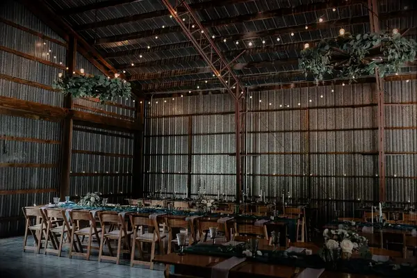 Rustic Barn Reception with Hanging Greenery and String Lights