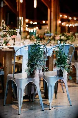 Metal Sweetheart Chairs with Greenery barn wedding venue