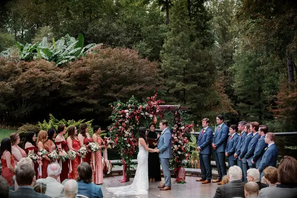 Red and Orange Florals Decorated This Fall Wedding Ceremony Arch