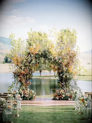 Fall Wedding Ceremony Arch With Orange Leaves