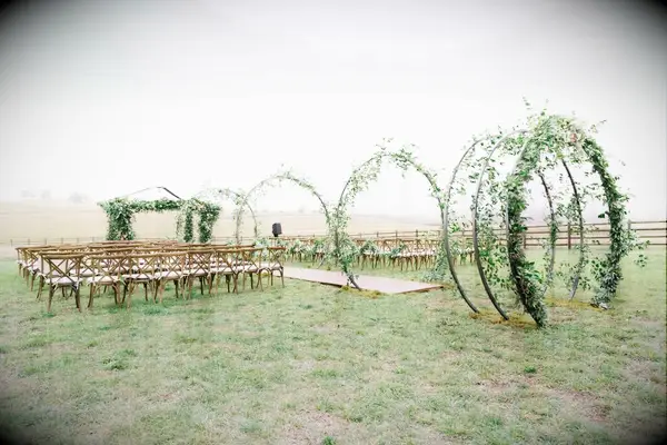 Steel Hoop Aisle Arches Covered in Eucalyptus and Greenery