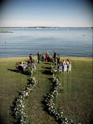 Waterfront Wedding Ceremony with Curved Floral Aisle