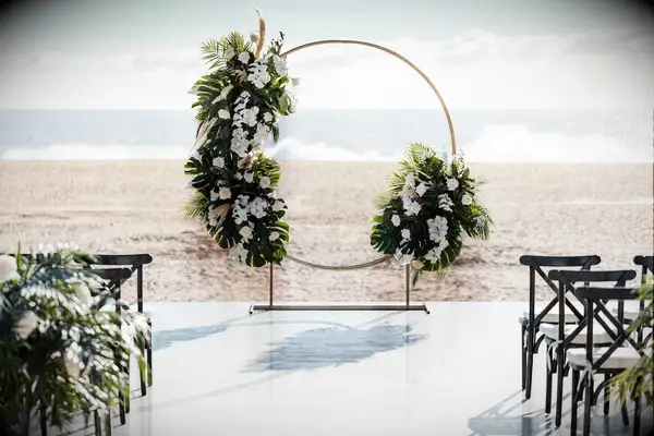 Beach Wedding Ceremony With a Circle Arch