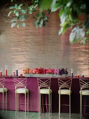 hightop wedding bar with gold chameleon chair barstools and ombre flower centerpiece