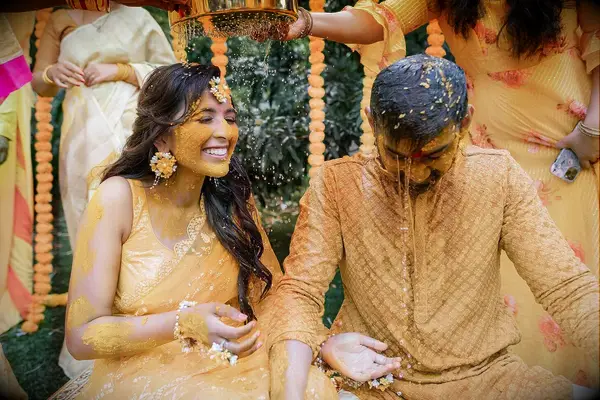 Bride and Groom Doused in Yellow Tumeric at Haldi Ceremony, Traditional Indian Wedding