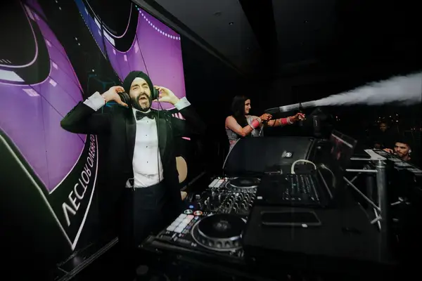 Groom in a Black Tuxedo and Turban Plays DJ, Bride Shoots Smoke at Reception