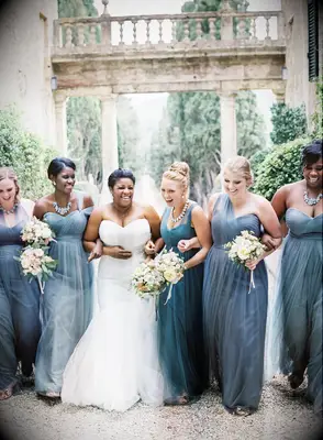 Bridesmaids laughing with bride on wedding day