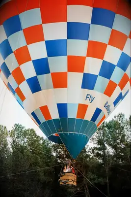 Bride and Groom in Massive Blue, White and Red Hot Air Balloon Entrance