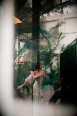 Artistic Film Through Window of Bride Putting on Detachable Sleeves Before Wedding