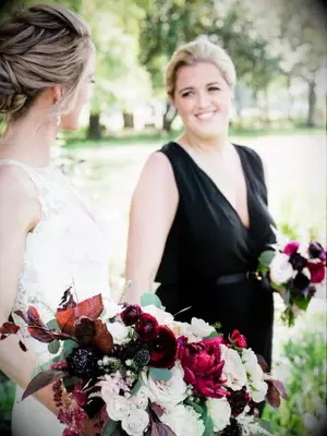 Two brides holding bouquets