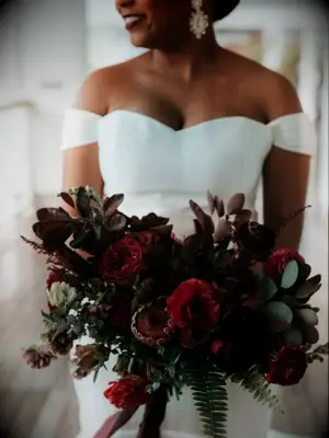 Bride holding dramatic burgundy bouquet