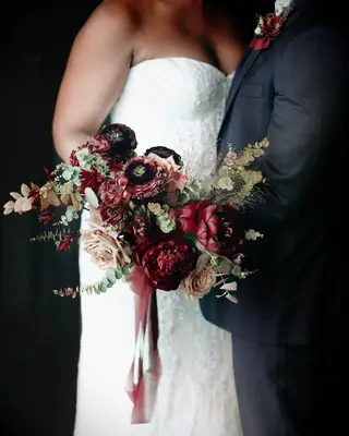 Bride holding burgundy bouquet