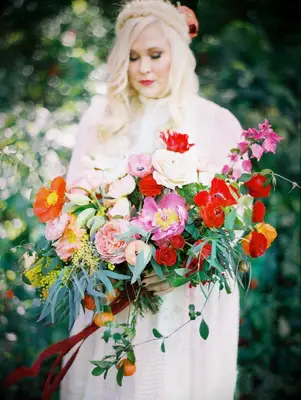bride holding pink-and-red wedding bouquet