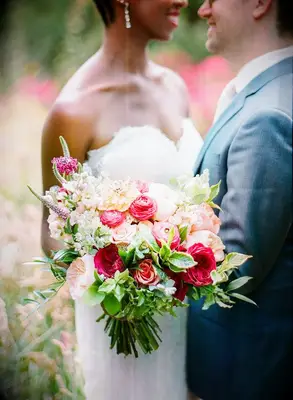 Couple hugging and holding bouquet