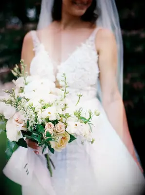 Bride holding green-and-white bouquet