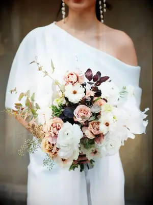 Bride holding fall wedding bouquet