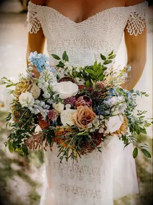 Bride holding boho brown wedding bouquet