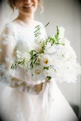 Bride holding white-and-green bouquet