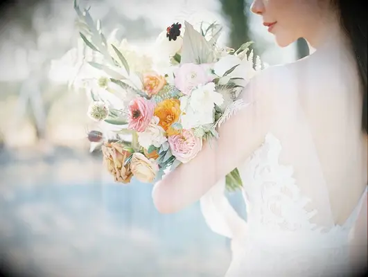 Bride holding wildflower-inspired bouquet in the desert