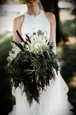 greenery bouquet for fall wedding with bay leaves, white protea, burgundy amaranthus and eucalyptus