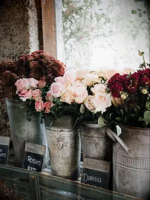 European-inspired metal buckets with fresh roses and delphiniums as wedding decor