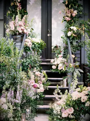 Stoop decorated with lush wedding flowers and candles