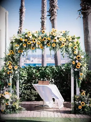 Sunflower arch over wedding ceremony altar at outdoor venue