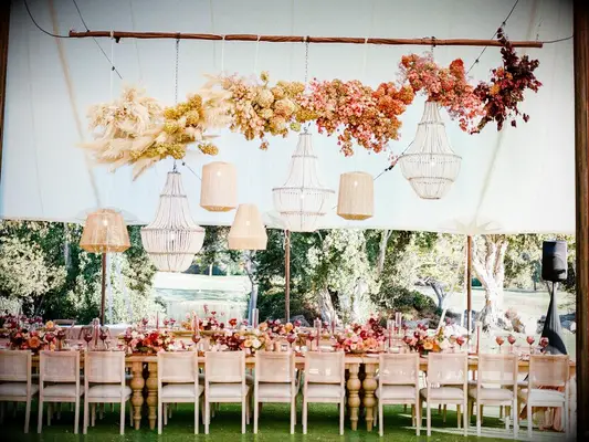 Suspended ombré floral installation at tented wedding reception